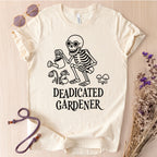 White t-shirt with skeleton graphic and 'DEADICATED GARDENER' text on a light wooden surface.