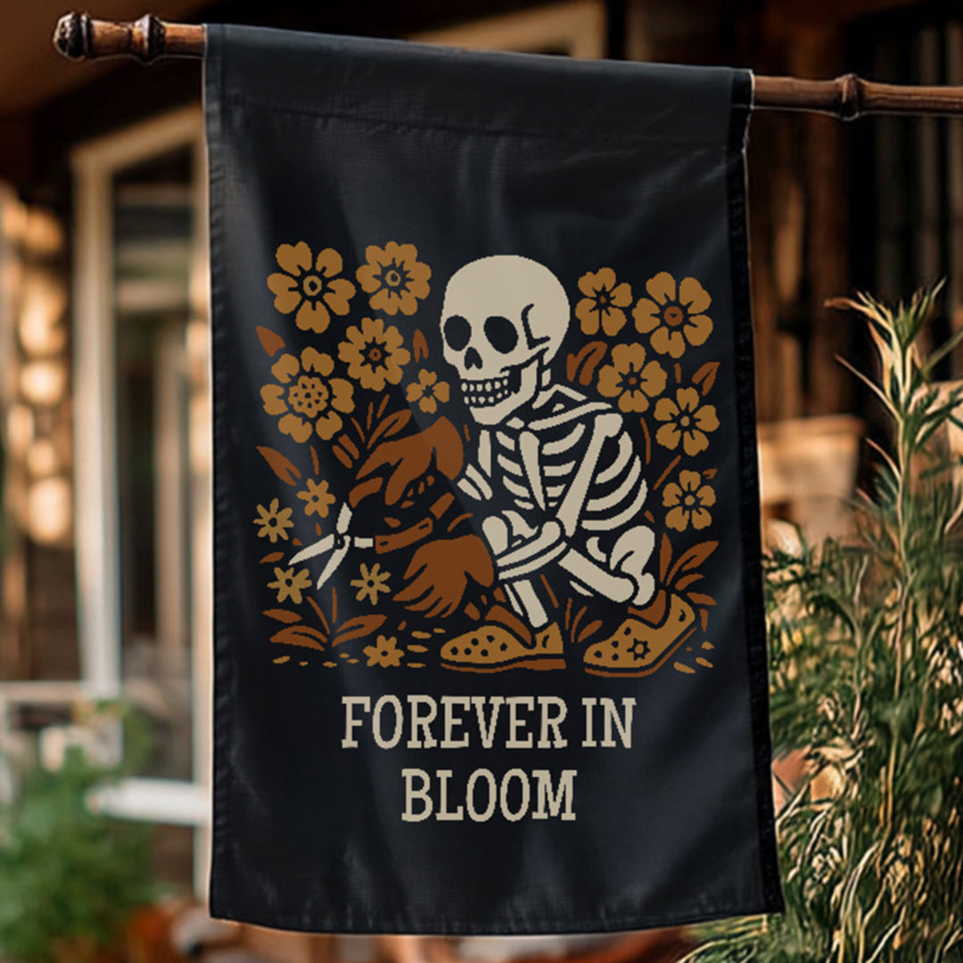 Decorative flag with a skeleton and flowers design, featuring the text 'Forever in Bloom', hanging outdoors.