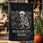 Decorative flag with a skeleton and floral design, featuring the text 'No Bloom Left Behind', hanging outdoors.