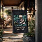 Decorative flag with a skeleton and floral design hanging outside a building.