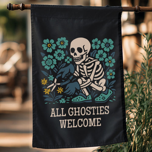 Decorative garden flag with a skeleton and floral design, featuring the text 'All Ghosties Welcome', hanging outdoors.
