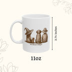 White mug with illustrations of three animals wearing hats and the text 'kindred magic', displayed with measurements on a white background.